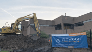 Ivywood building with construction happening in front of it and Ivywood banner.