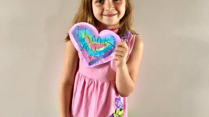 Student holding heart note for healthcare workers