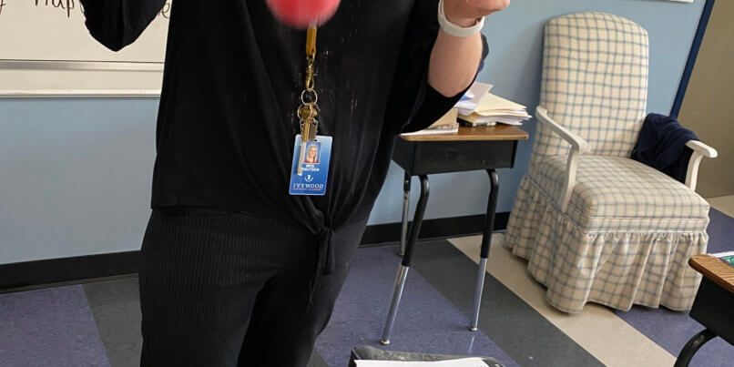 Teacher performing experiment with flour and ball