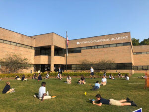 Students social distanced and reading outside