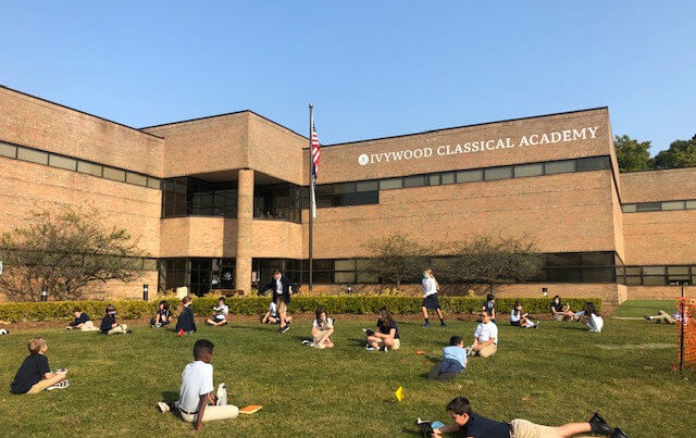 Students social distanced and reading outside