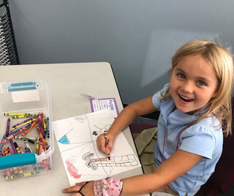Kindergarten Student coloring a picture