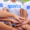 IPO1 people with their hands together wearing volunteer shirts