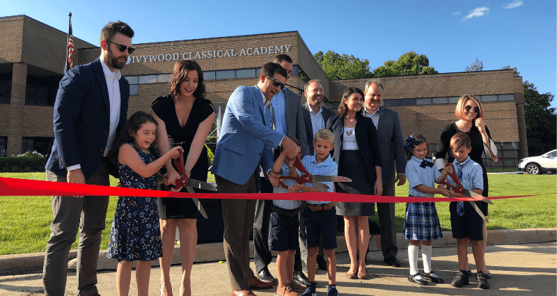Ivywood founding board members cutting the ribbon with their kids during building launch