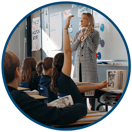 Circle image of teacher instructing students