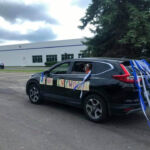 Car with streamers and "We love Ivywood" on the windows