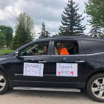 Vehicle with signs that say "Ivywood Walk-A-Thon" and "Ivywood Rocks!"